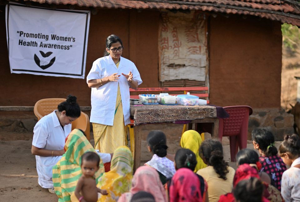 senior female volunteer leads a women's health clinic in rural India