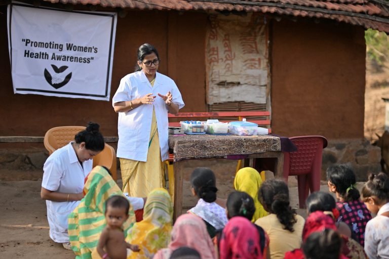 senior female volunteer leads a women's health clinic in rural India